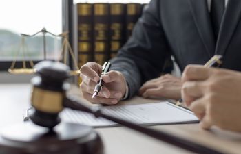 A lawyer revising documents and advising a client.