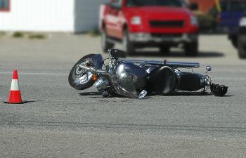 Crashed motorcycle lying on the road after an accident.